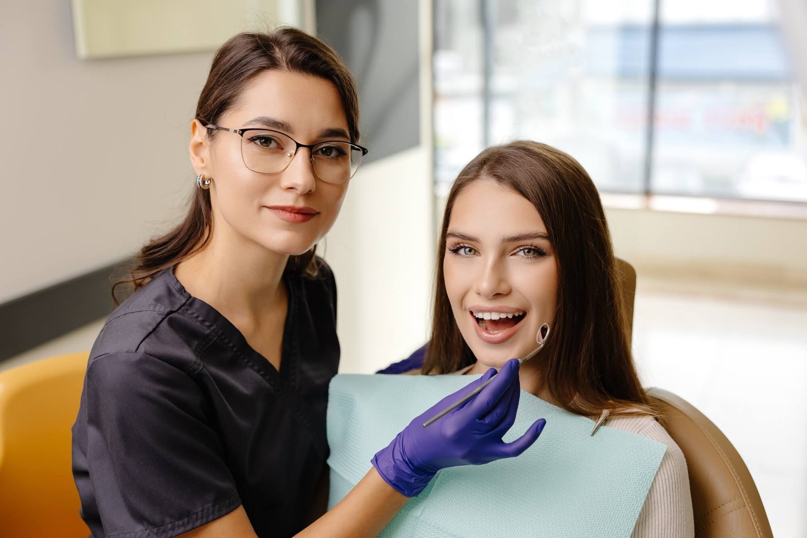 female-dentist-examines-patient-smiling-in-dental-2026-03-26-10-24-55-utc-1.jpg